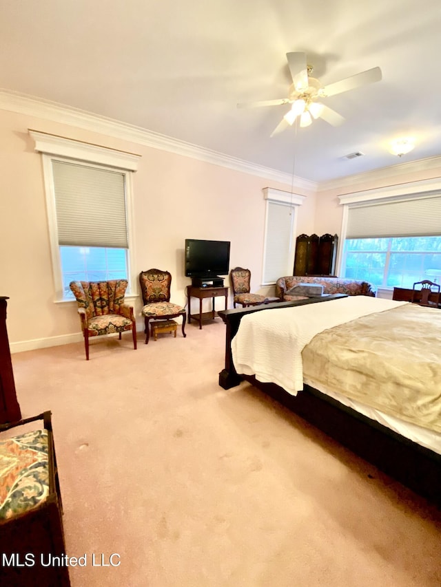 carpeted bedroom featuring ceiling fan and ornamental molding