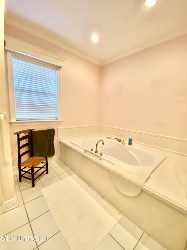 bathroom with tile patterned floors, crown molding, and a tub