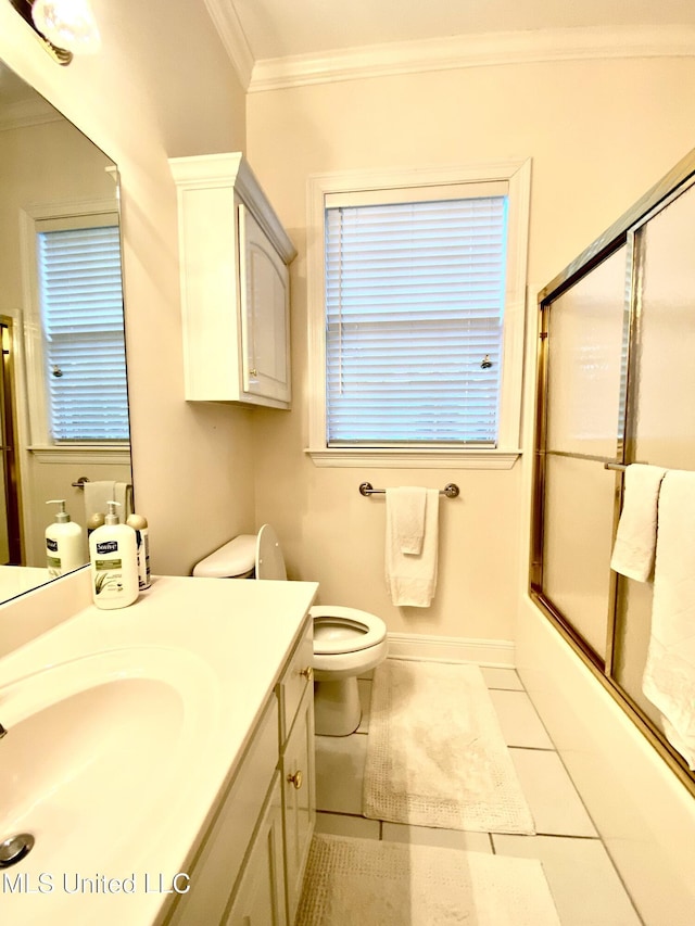 full bathroom featuring combined bath / shower with glass door, tile patterned floors, vanity, crown molding, and toilet