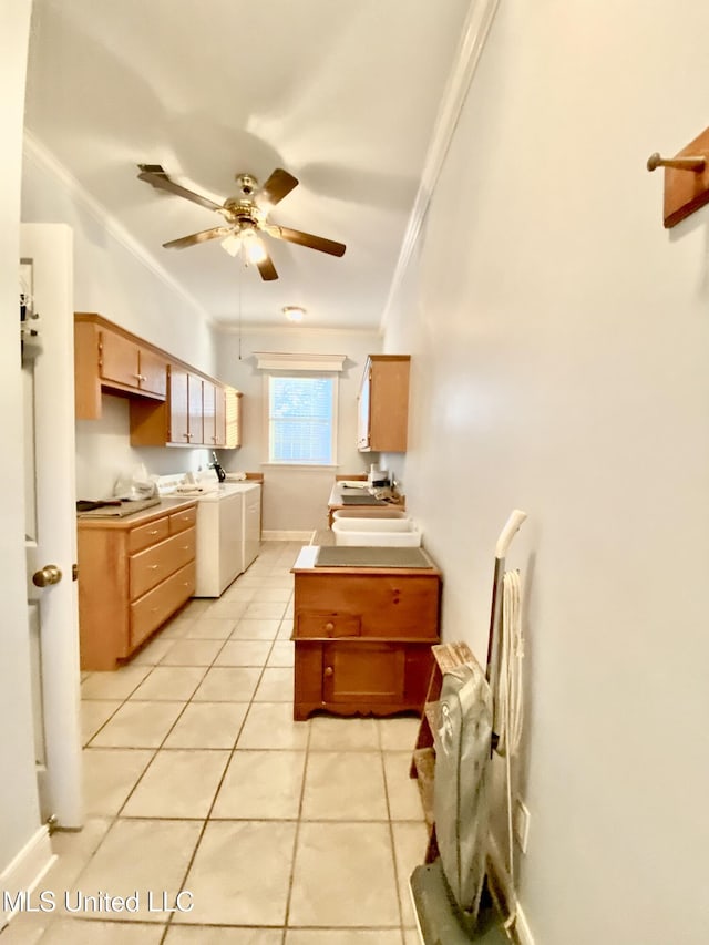 kitchen with washer and dryer, ceiling fan, crown molding, and light tile patterned flooring