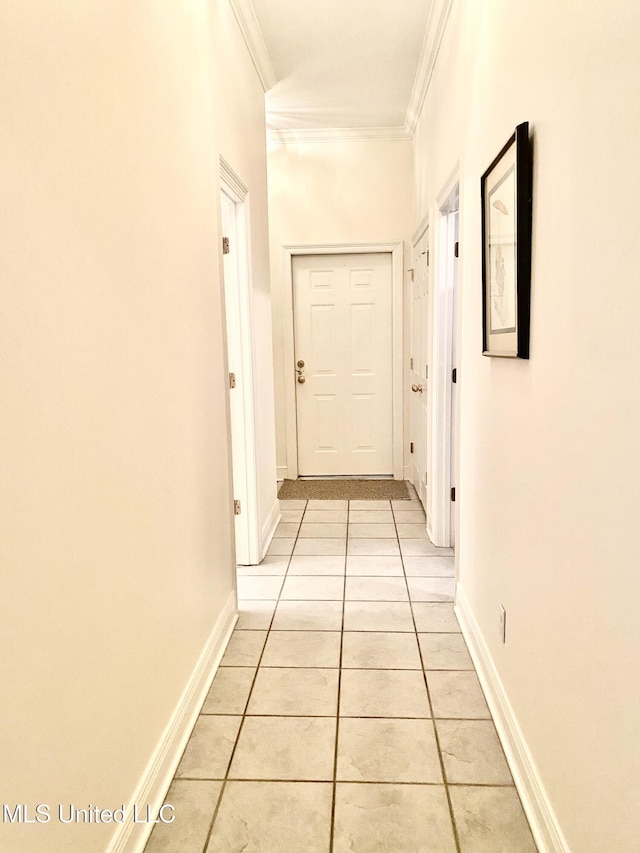 hall featuring ornamental molding and light tile patterned floors