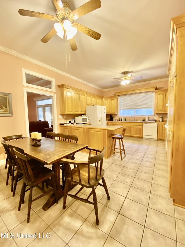 dining space featuring ceiling fan, light tile patterned floors, and crown molding