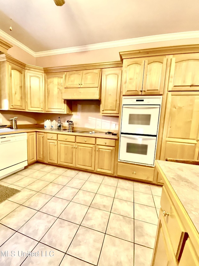 kitchen with light tile patterned flooring, white appliances, ornamental molding, and light brown cabinets