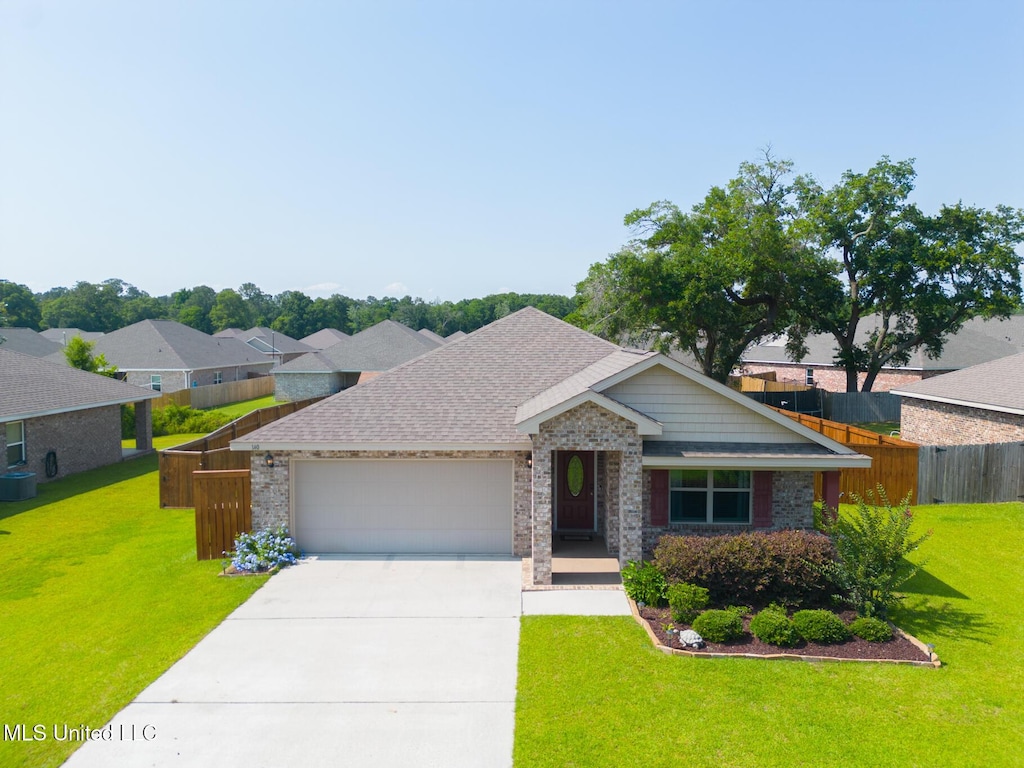 140 Rosie Dr, Long Beach, MS 39560 - view of front of house with a garage, concrete driveway, and roof with shingles