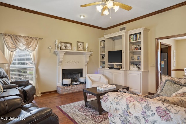 725 Bay Tree Dr, Flowood, MS 39232 - living area with ceiling fan, wood finished floors, ornamental molding, and a brick fireplace