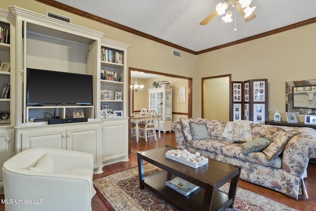 725 Bay Tree Dr, Flowood, MS 39232 - living room with dark wood finished floors, a ceiling fan, a chandelier, and ornamental molding