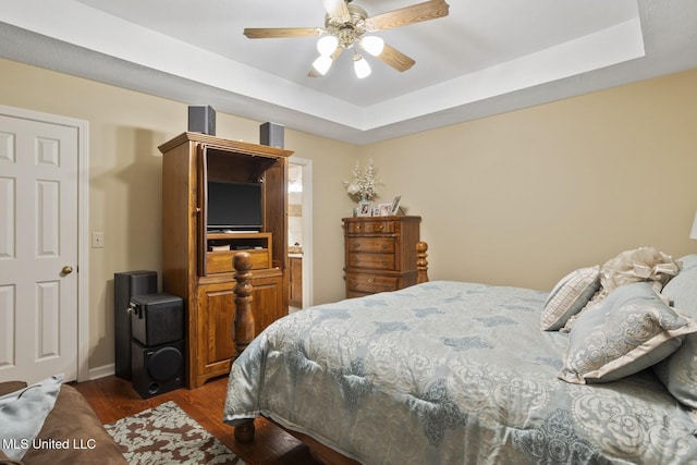 725 Bay Tree Dr, Flowood, MS 39232 - bedroom featuring dark wood-type flooring, a tray ceiling, and ceiling fan