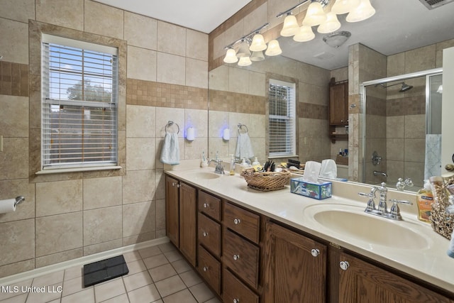 725 Bay Tree Dr, Flowood, MS 39232 - full bathroom with tile walls, double vanity, tile patterned floors, and a shower stall