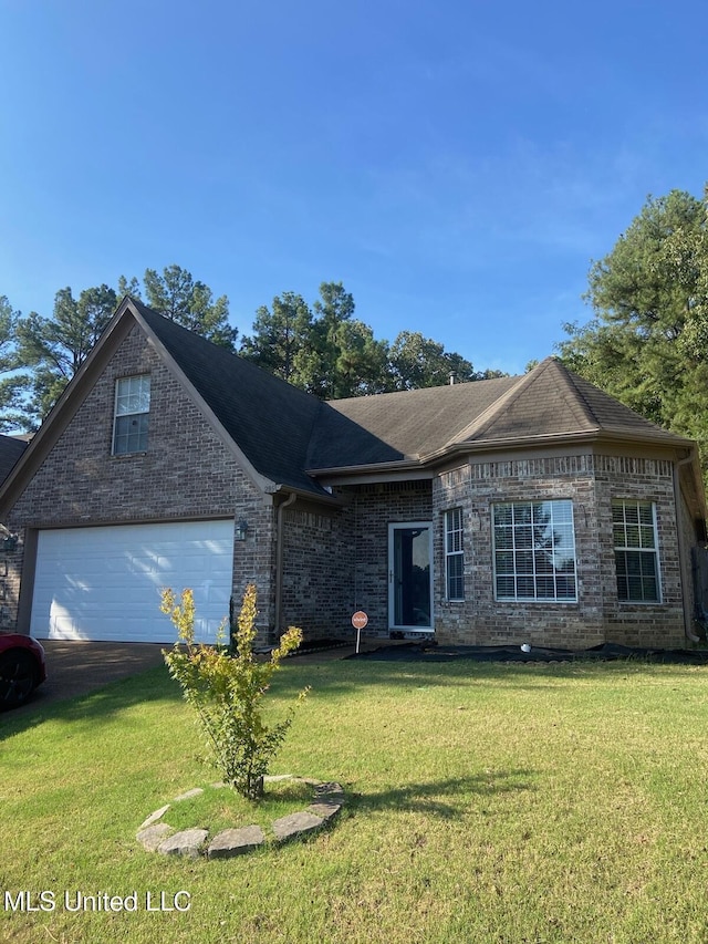 view of front of home with a garage and a front lawn