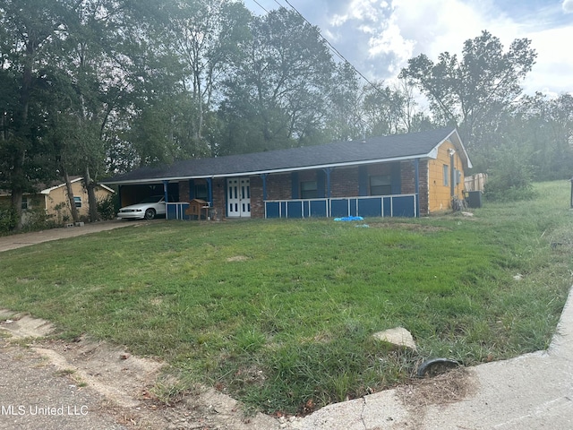 exterior space with a front lawn, central AC unit, and a carport