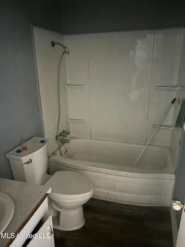 full bathroom with  shower combination, vanity, wood-type flooring, and toilet