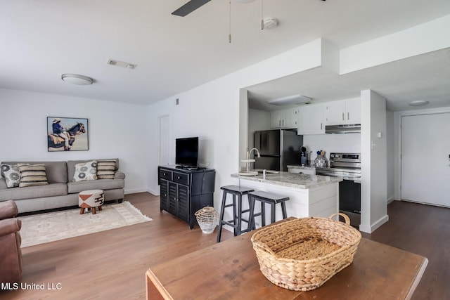138 Molokai Vlg Unit J, Diamondhead, MS 39525 - living area with light wood finished floors, baseboards, and a ceiling fan