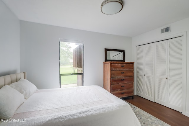 138 Molokai Vlg Unit J, Diamondhead, MS 39525 - bedroom with dark wood-type flooring and a closet