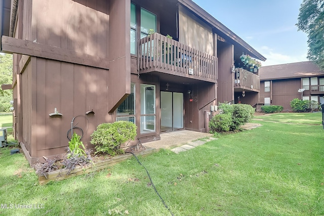 138 Molokai Vlg Unit J, Diamondhead, MS 39525 - rear view of property featuring a lawn