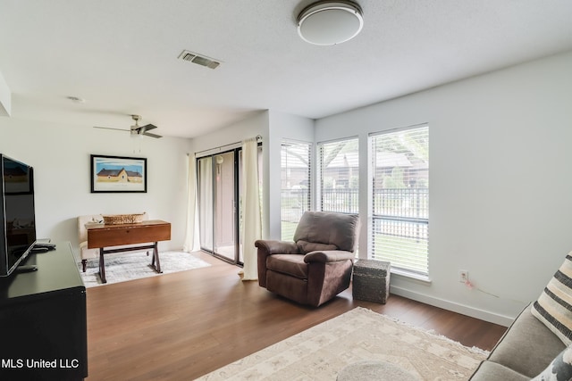 138 Molokai Vlg Unit J, Diamondhead, MS 39525 - living area with wood finished floors, baseboards, and a ceiling fan