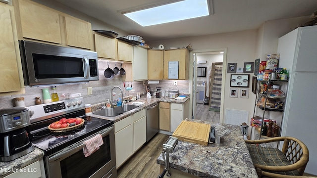 22386 Ms Highway 32, Oakland, MS 38948 - kitchen featuring light brown cabinets, a sink, decorative backsplash, appliances with stainless steel finishes, and dark wood-type flooring