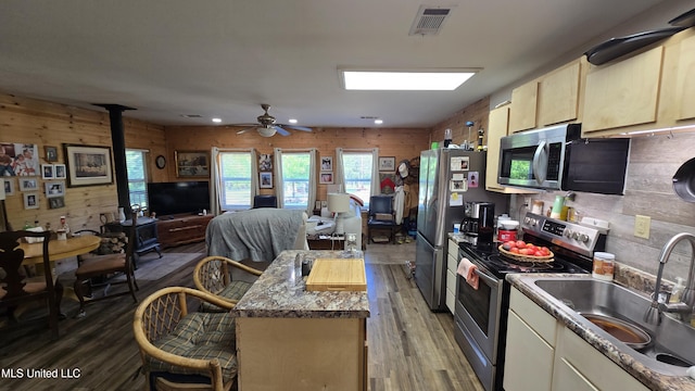 22386 Ms Highway 32, Oakland, MS 38948 - kitchen featuring wooden walls, wood finished floors, visible vents, a sink, and appliances with stainless steel finishes