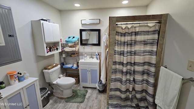 22386 Ms Highway 32, Oakland, MS 38948 - full bathroom with recessed lighting, wood finished floors, toilet, vanity, and a shower with curtain