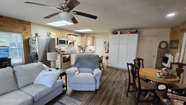 22386 Ms Highway 32, Oakland, MS 38948 - living room with heating unit, a ceiling fan, wooden walls, and dark wood-style floors