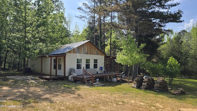 22386 Ms Highway 32, Oakland, MS 38948 - rear view of house with cooling unit, a yard, metal roof, and a deck