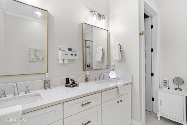 bathroom with tile patterned flooring, crown molding, and vanity