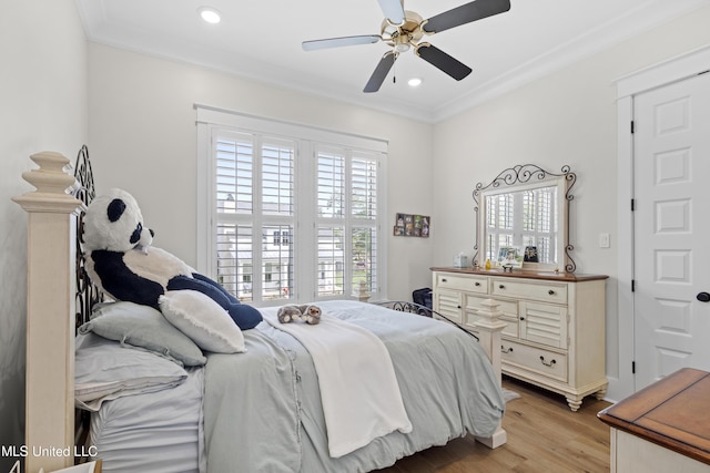 bedroom featuring ceiling fan, ornamental molding, and light wood-type flooring