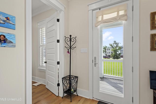 entryway featuring light hardwood / wood-style flooring and crown molding