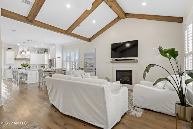 living room featuring lofted ceiling with beams and dark hardwood / wood-style flooring