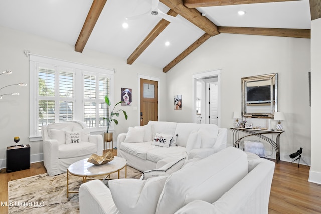 living room featuring ceiling fan, lofted ceiling with beams, and wood-type flooring