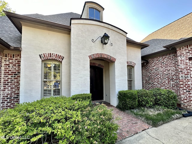 121 Vinca Dr, Madison, MS 39110 - entrance to property featuring a shingled roof and brick siding