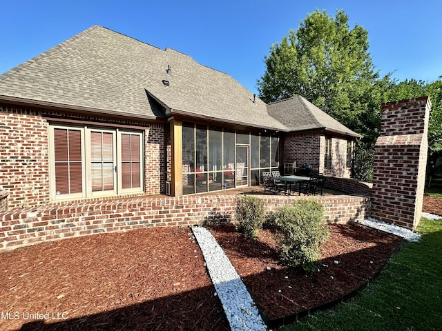 121 Vinca Dr, Madison, MS 39110 - back of house with a sunroom, roof with shingles, a patio, and brick siding
