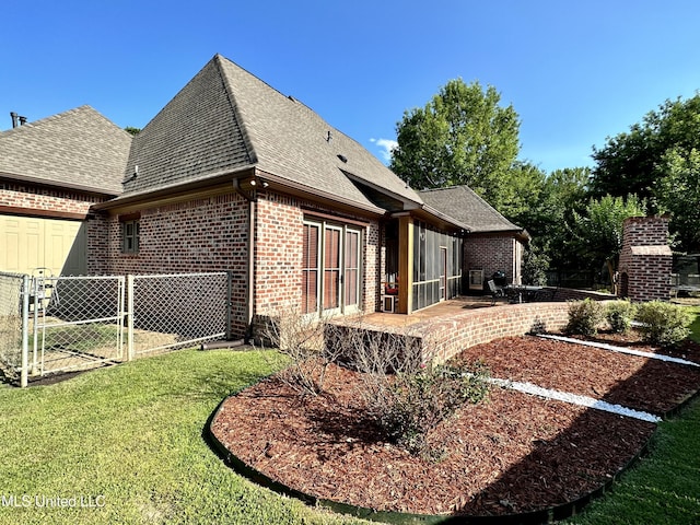 121 Vinca Dr, Madison, MS 39110 - rear view of property with brick siding, a shingled roof, a patio, a gate, and an attached garage