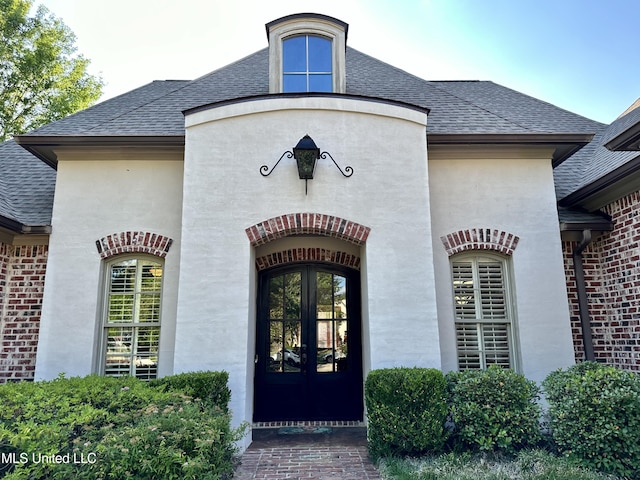 121 Vinca Dr, Madison, MS 39110 - property entrance with roof with shingles, french doors, and brick siding
