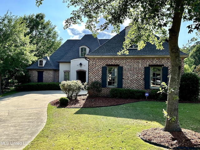 121 Vinca Dr, Madison, MS 39110 - french country style house with roof with shingles, a front lawn, driveway, and brick siding