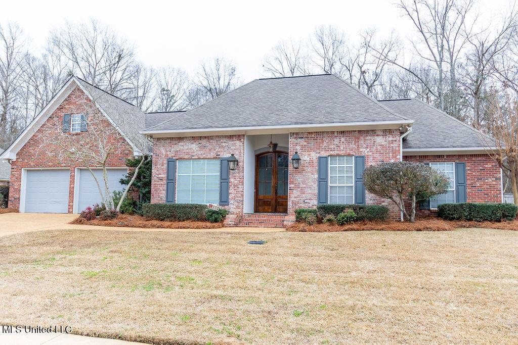 view of front of house featuring a garage and a front lawn