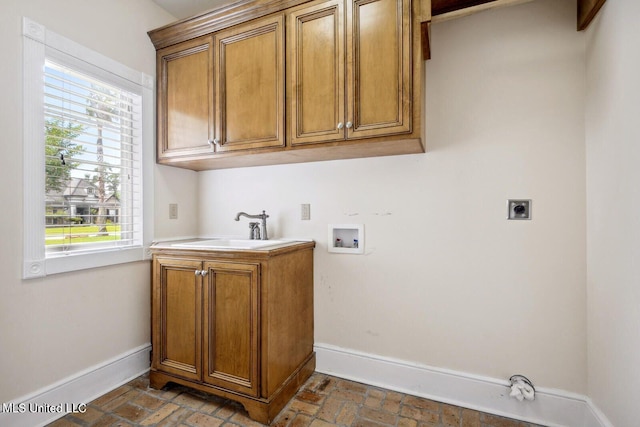 laundry area with washer hookup, cabinets, sink, and electric dryer hookup