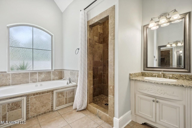 bathroom featuring shower with separate bathtub, tile patterned floors, and vanity