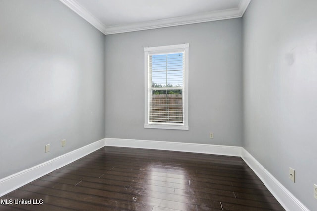 spare room with dark wood-type flooring and crown molding