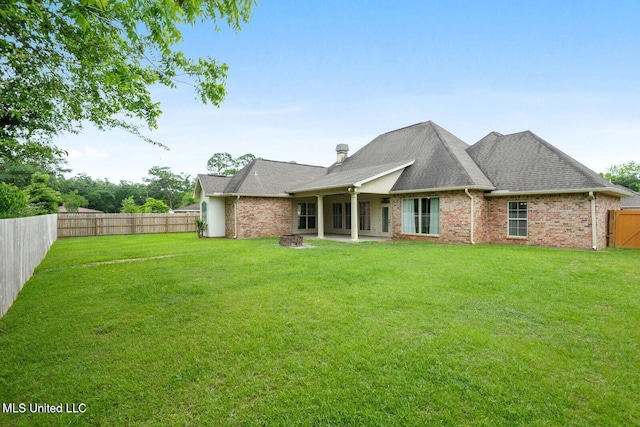 back of house with a yard and a patio area