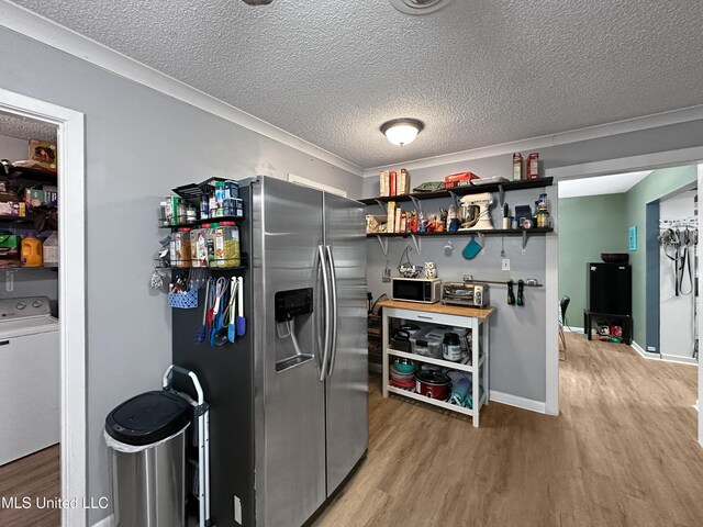 1008 Normandy Dr, Clinton, MS 39056 - kitchen featuring stainless steel appliances, washer / dryer, open shelves, light wood-type flooring, and a textured ceiling