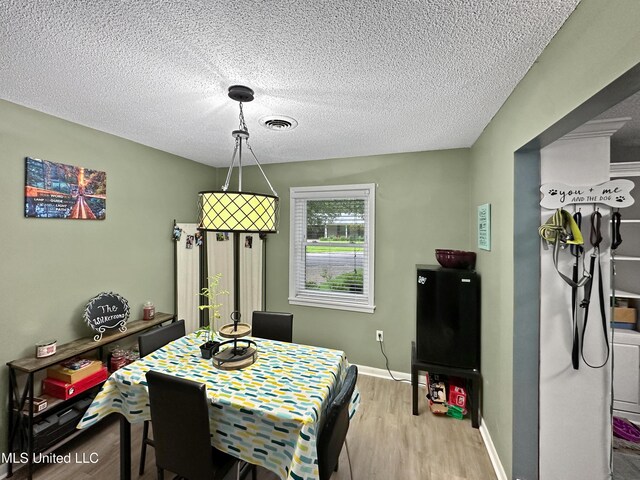 1008 Normandy Dr, Clinton, MS 39056 - dining room featuring wood finished floors, a textured ceiling, and baseboards