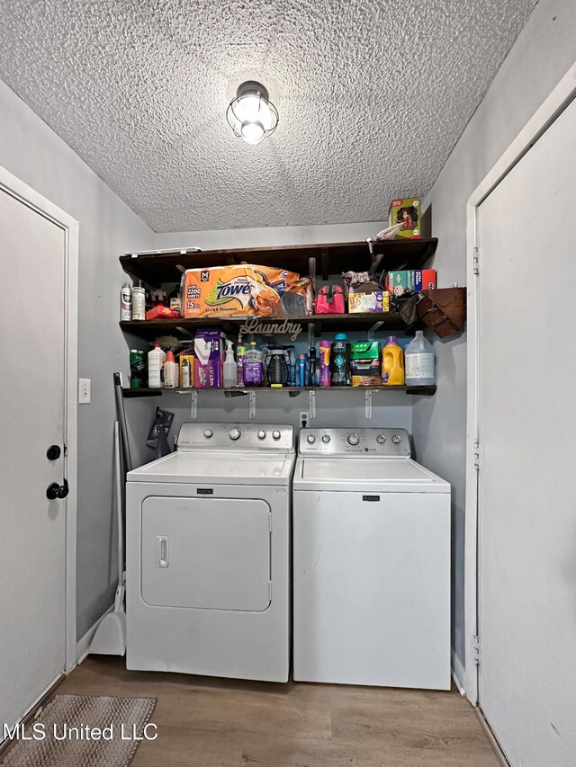 1008 Normandy Dr, Clinton, MS 39056 - laundry room with separate washer and dryer, a textured ceiling, and wood finished floors