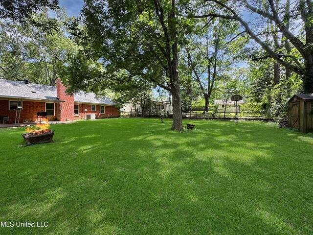 1008 Normandy Dr, Clinton, MS 39056 - view of green lawn featuring an outdoor fire pit