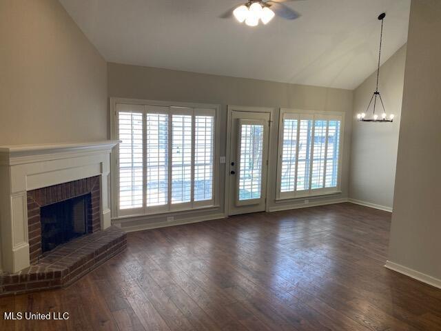 4 Foxcroft Ct, Madison, MS 39110 - unfurnished living room with lofted ceiling, ceiling fan, a brick fireplace, healthy amount of natural light, and baseboards