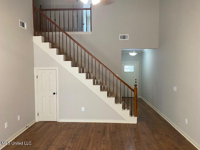 4 Foxcroft Ct, Madison, MS 39110 - stairs featuring a towering ceiling, baseboards, wood finished floors, and a ceiling fan