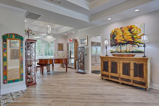205 Audubon Point Dr, Brandon, MS 39047 - foyer entrance with visible vents, ornamental molding, light wood-style flooring, and a raised ceiling