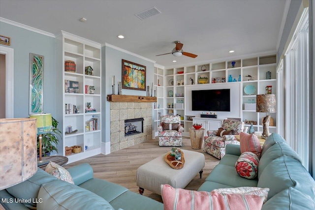 205 Audubon Point Dr, Brandon, MS 39047 - living area featuring built in features, a ceiling fan, wood finished floors, visible vents, and ornamental molding