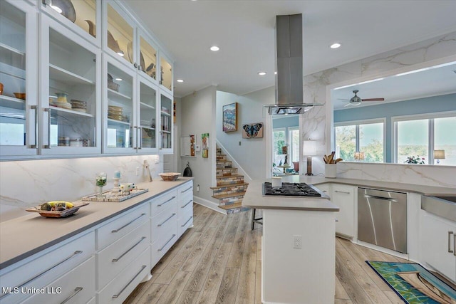 205 Audubon Point Dr, Brandon, MS 39047 - kitchen with decorative backsplash, ceiling fan, white cabinetry, light wood finished floors, and stainless steel appliances