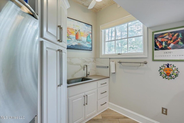 205 Audubon Point Dr, Brandon, MS 39047 - bathroom featuring a sink, baseboards, and wood finished floors