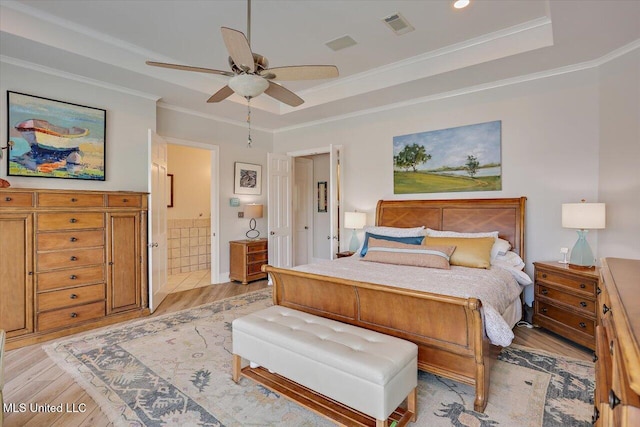 205 Audubon Point Dr, Brandon, MS 39047 - bedroom with visible vents, crown molding, connected bathroom, light wood-style floors, and a tray ceiling